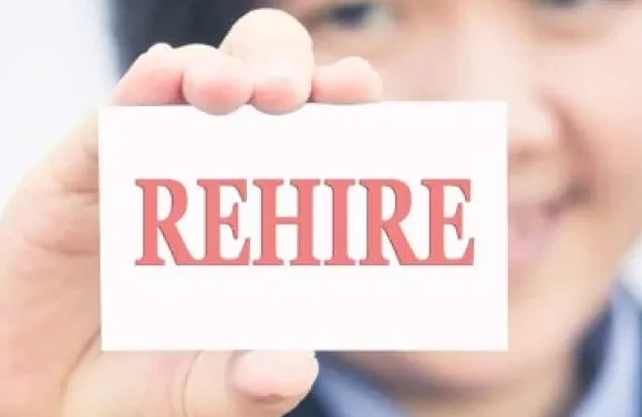 person holding a card that says 'rehire'