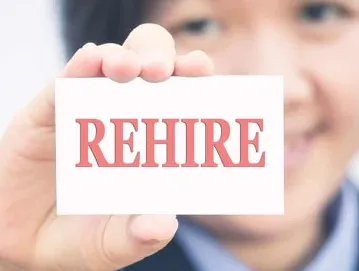 person holding a card that says 'rehire'